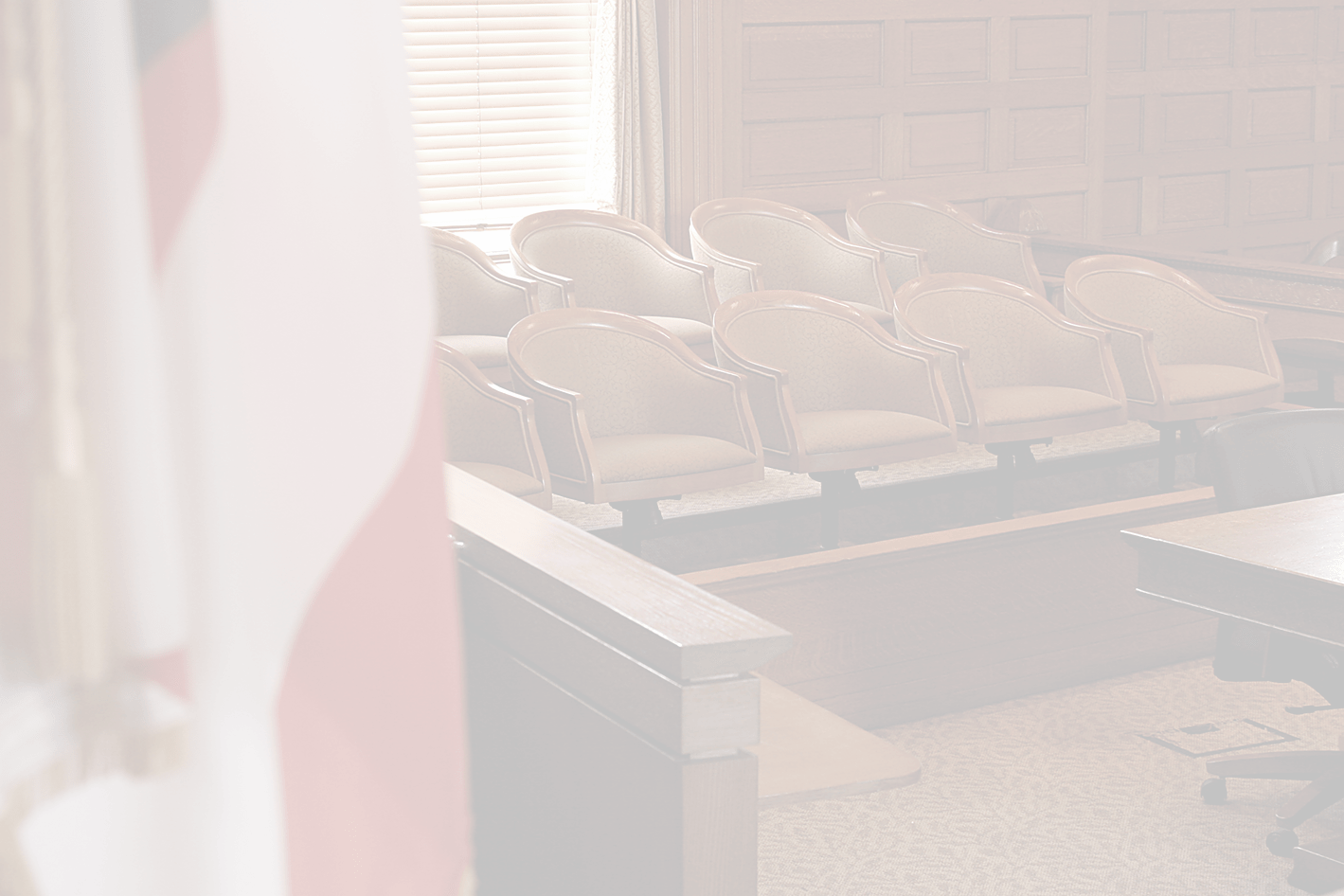 Jury box in a courtroom with American flag in foreground (transparent)
