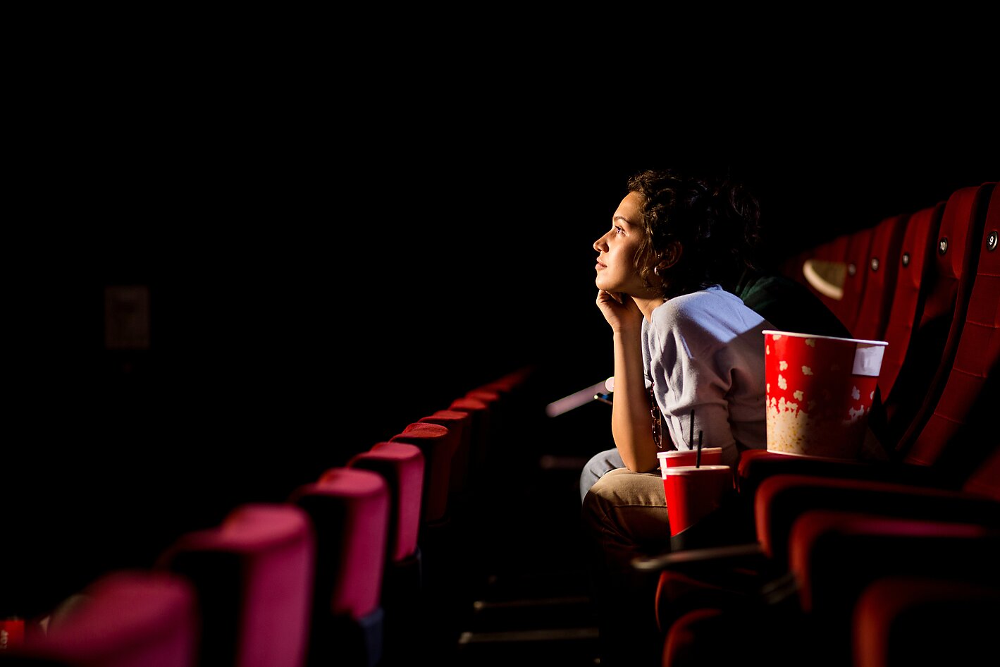 Girl watching movie in a movie theater