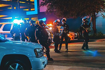 A group of police officers standing next to their squad cars in Phoenix, Arizona