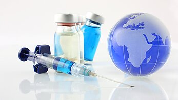 Vaccine vial with needle and globe