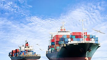 Cargo ships against a blue sky