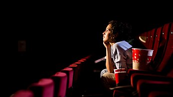 Girl watching movie in a movie theater