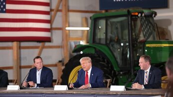 Trump speaking in front of a John Deere tractor