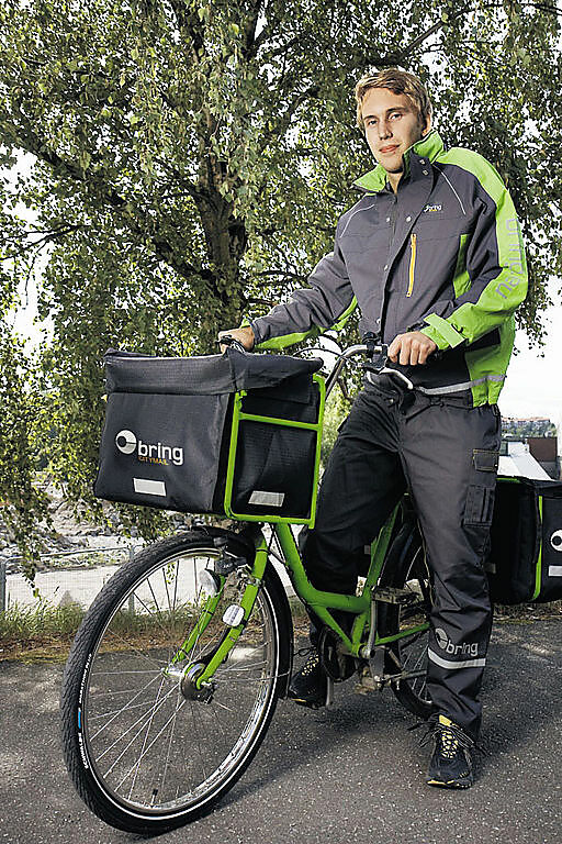 A picture of a "Citymail Cityman" on his bicycle