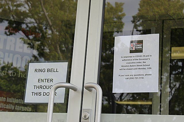 A sign on a closed local school because of the coronavirus. Photo by Breawycker
