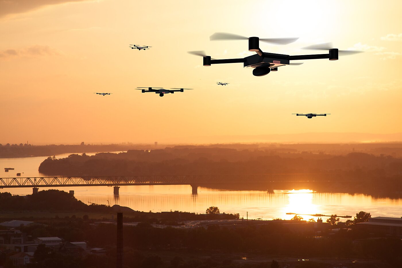 Drones in sunset sky.